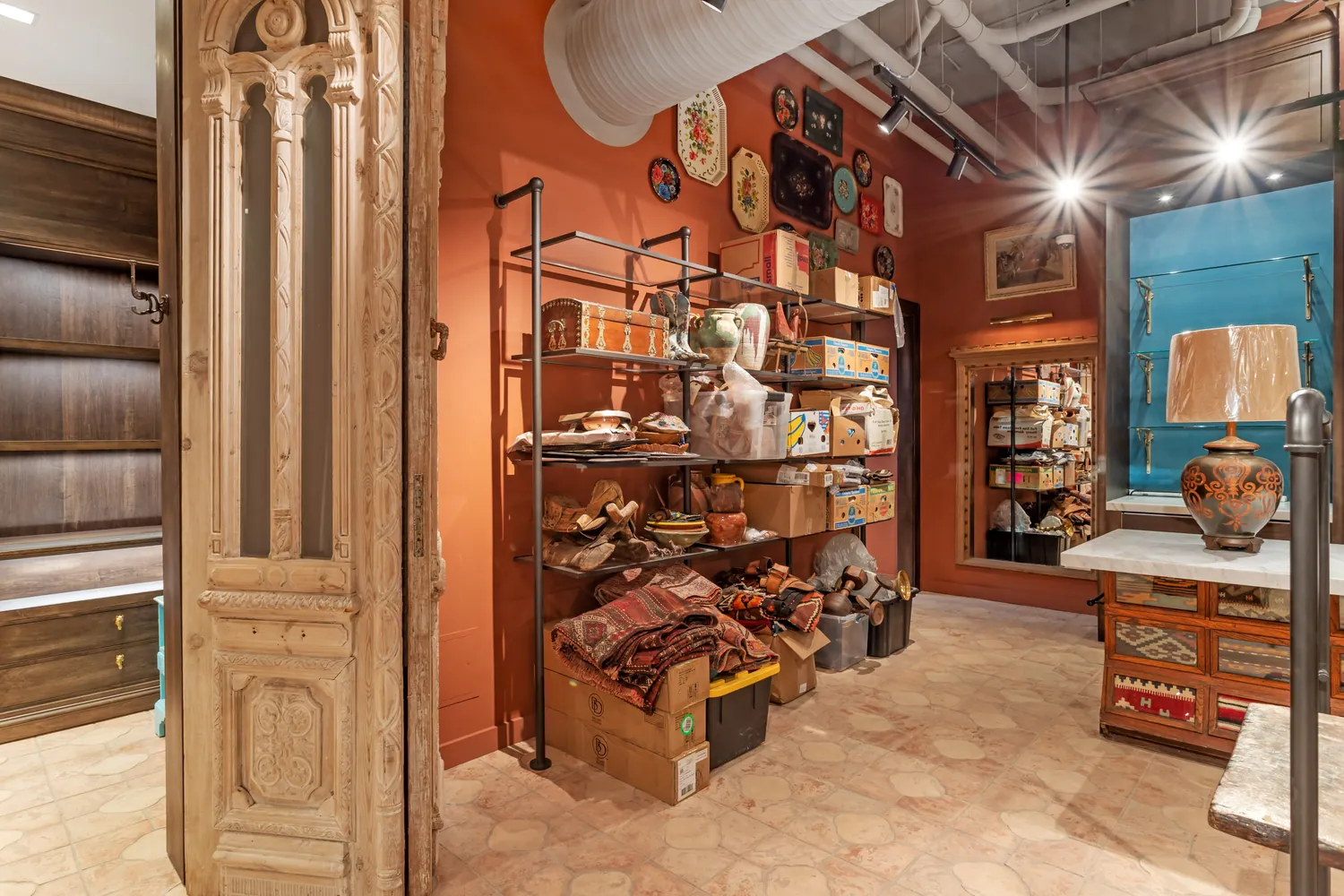 Yellow Rose by Kendra Scott — interior with antique carved doors and fixture wall