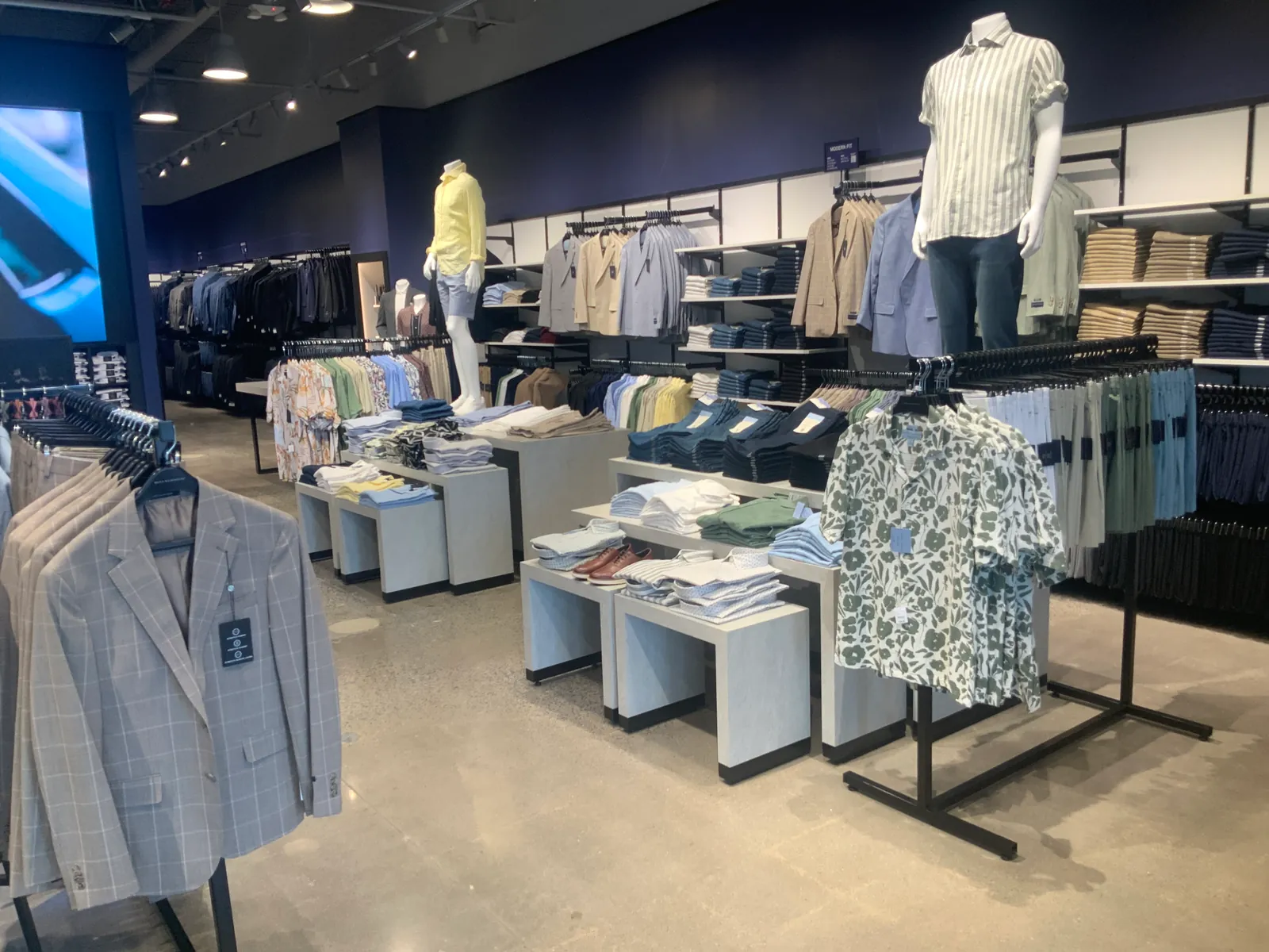 Men's Wearhouse retail floor — completed interior with fixtures and display tables