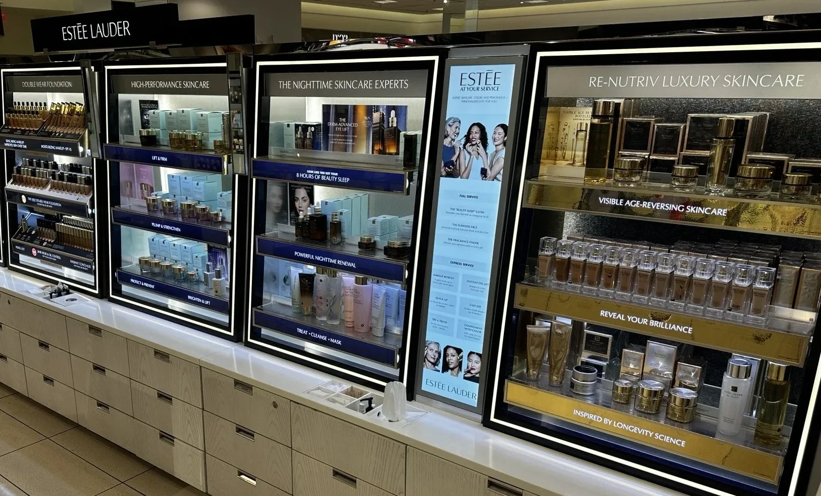 Nordstrom beauty refresh — Estée Lauder fixture run with backlit signage, completed