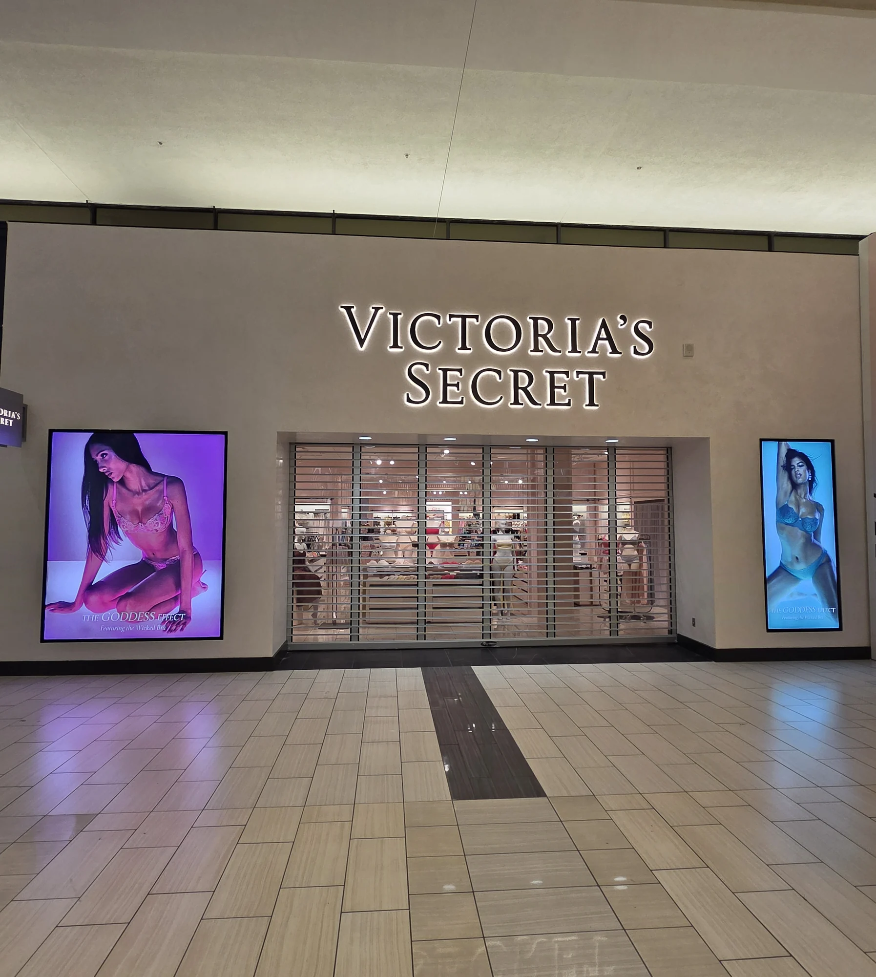 Victoria's Secret mall storefront — illuminated signage and brand entry
