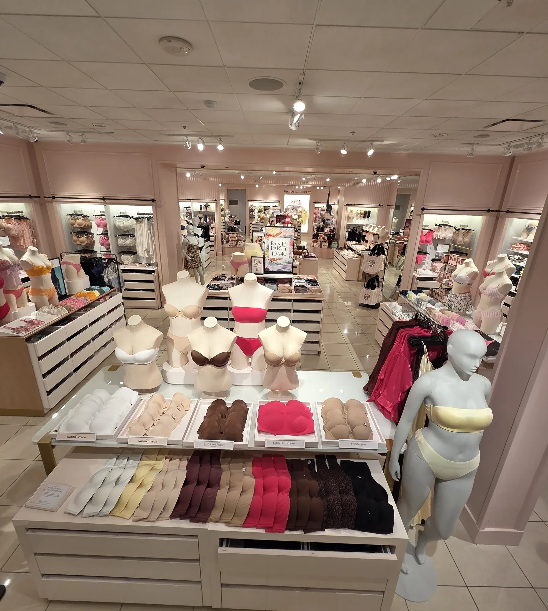 Victoria's Secret interior — display fixtures, bra tables and brand merchandising